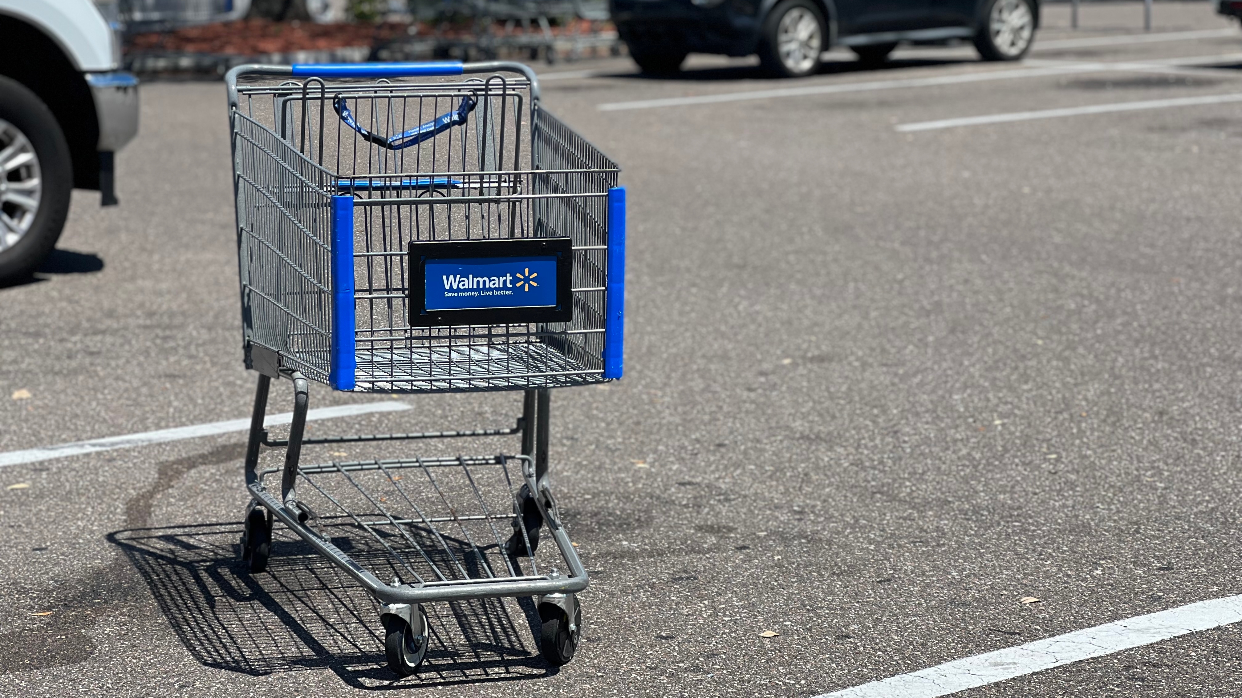 A shopping cart that has been left in a parking space.